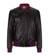 Black leather jacket with red and blue accents on a white background
